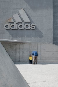 man-taking-photo-of-a-child-leaning-on-wall